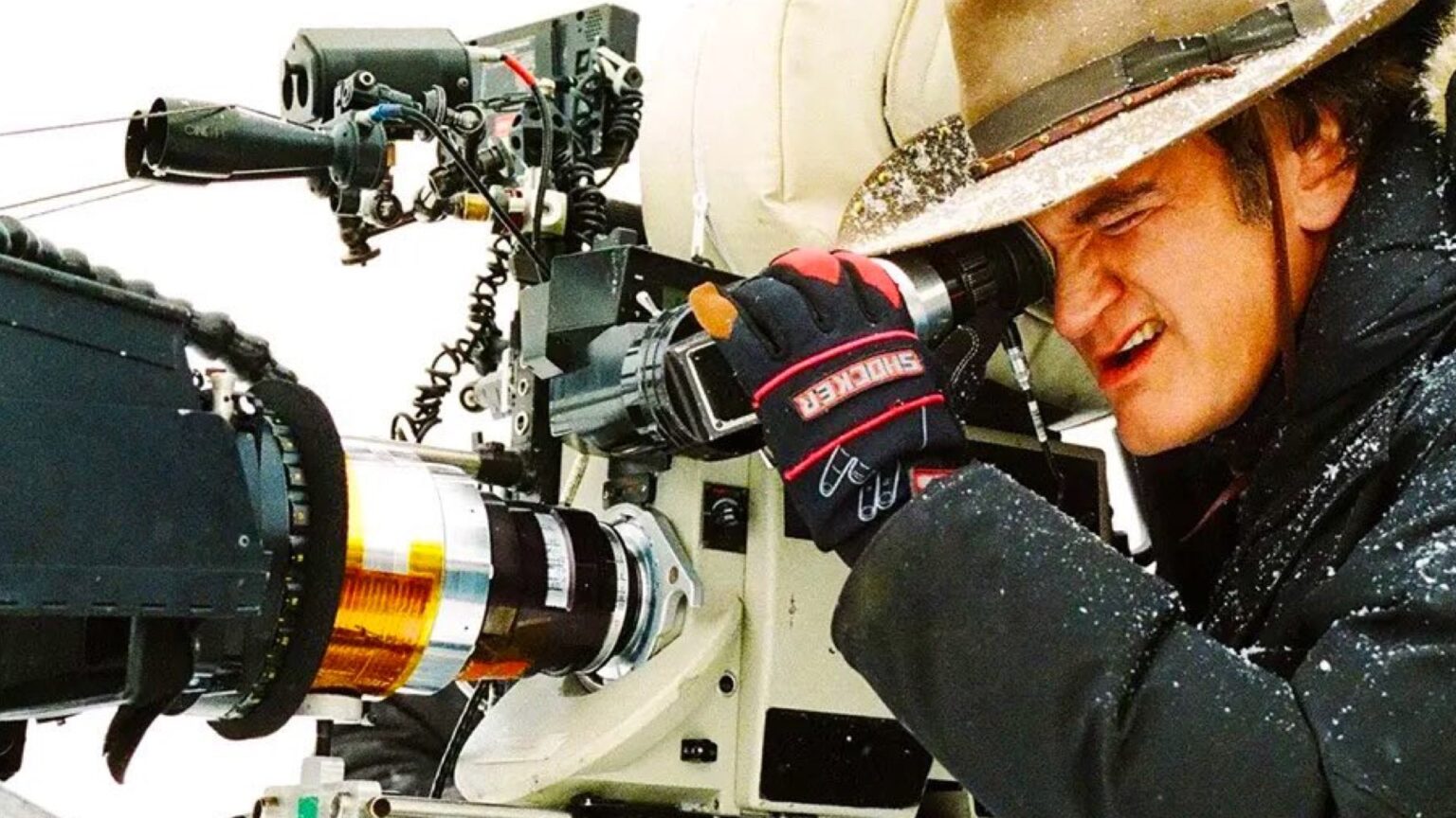 Quentin Tarantino filming a scene with vintage camera