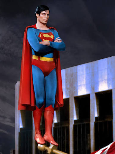 Christopher Reeve as Superman standing in classic pose